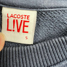 Sudadera Lacoste azul marino con logotipo Lacoste bordado visto desde la etiqueta